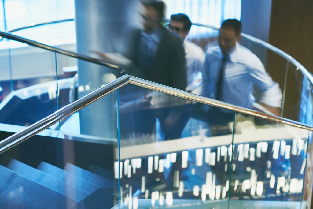 Group of businessmen going upstairs in office building